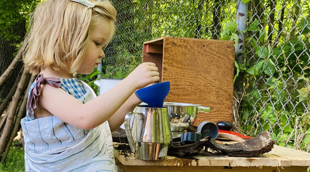 Mira in the mud kitchen